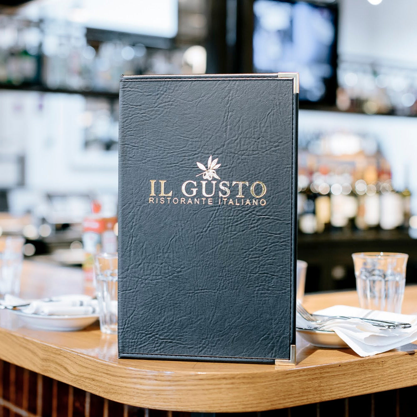 Black leatherette stitched edge menu cover in faux leather harley with debossed logo and corner protectors.