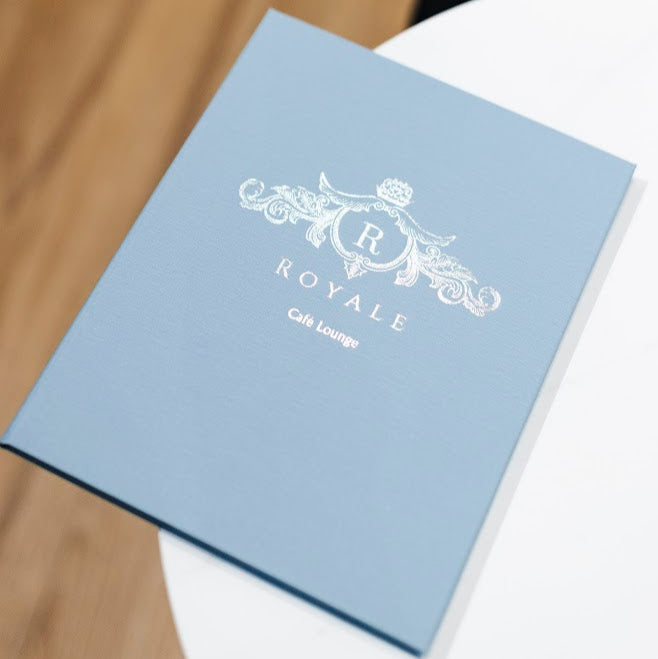 sky blue linen menu  cover with silver foil logo 